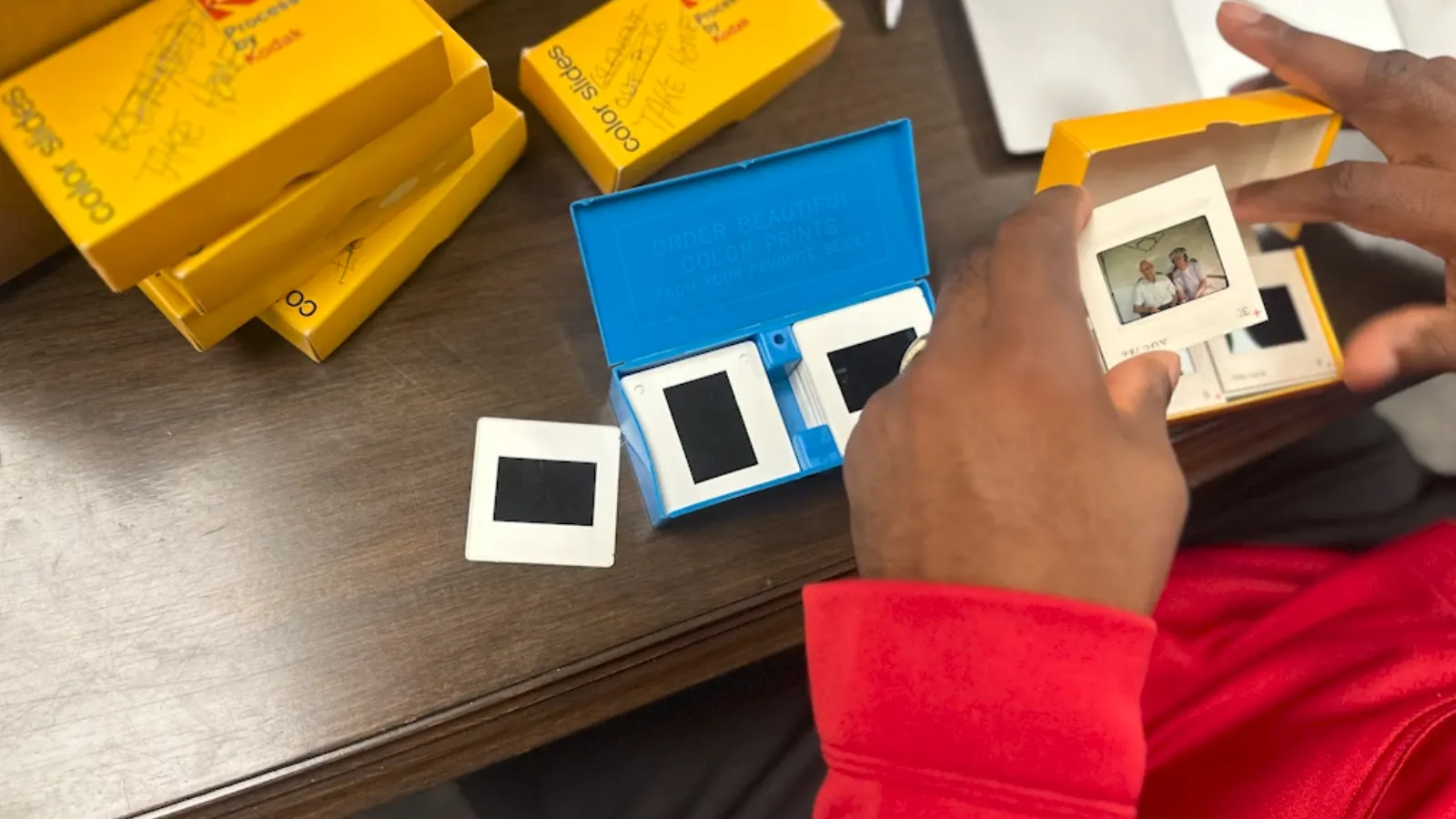 Student researcher holding slide in his hands above table