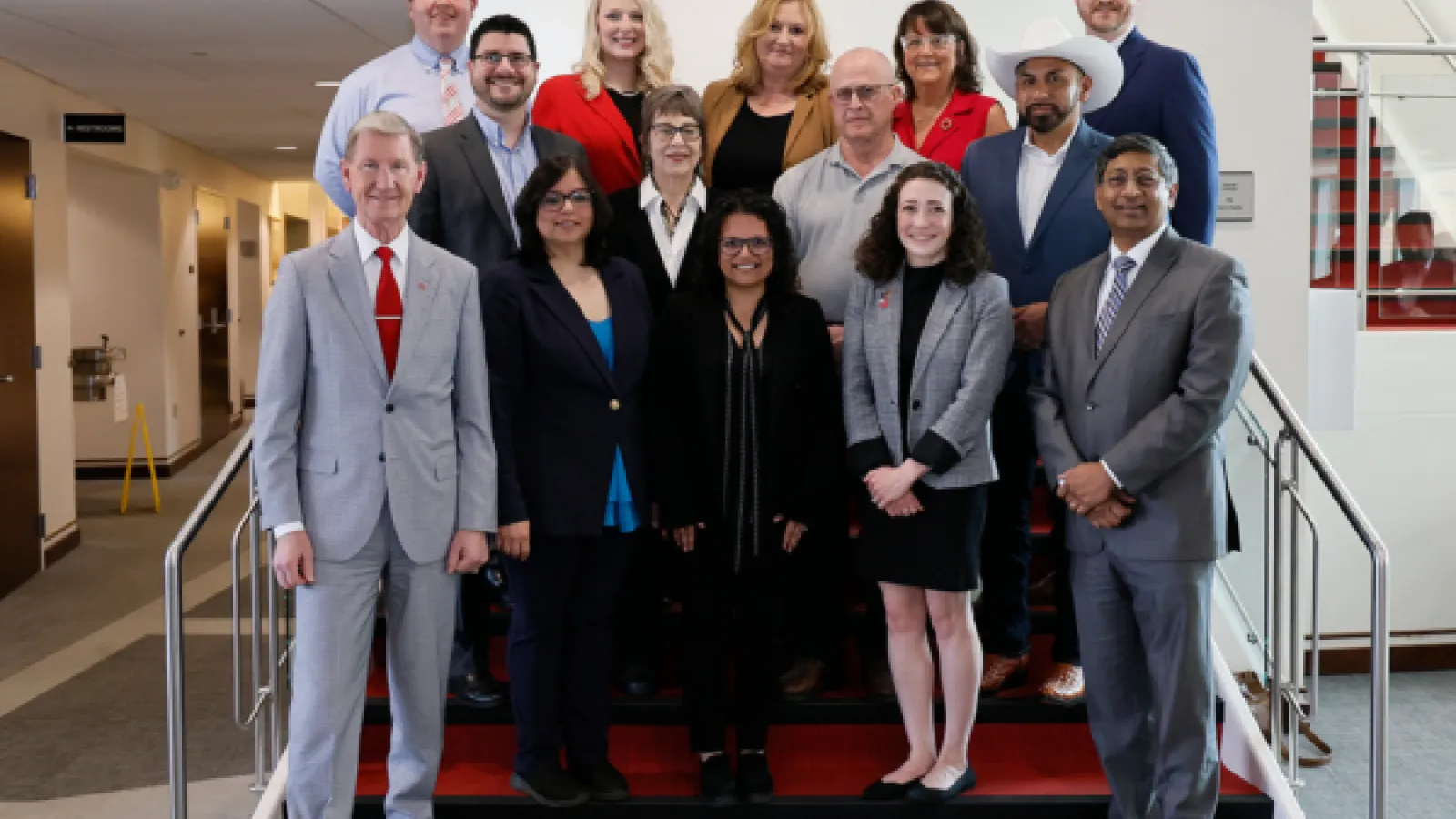 the recipients of the 2025 distinguished staff awards standing on stairs