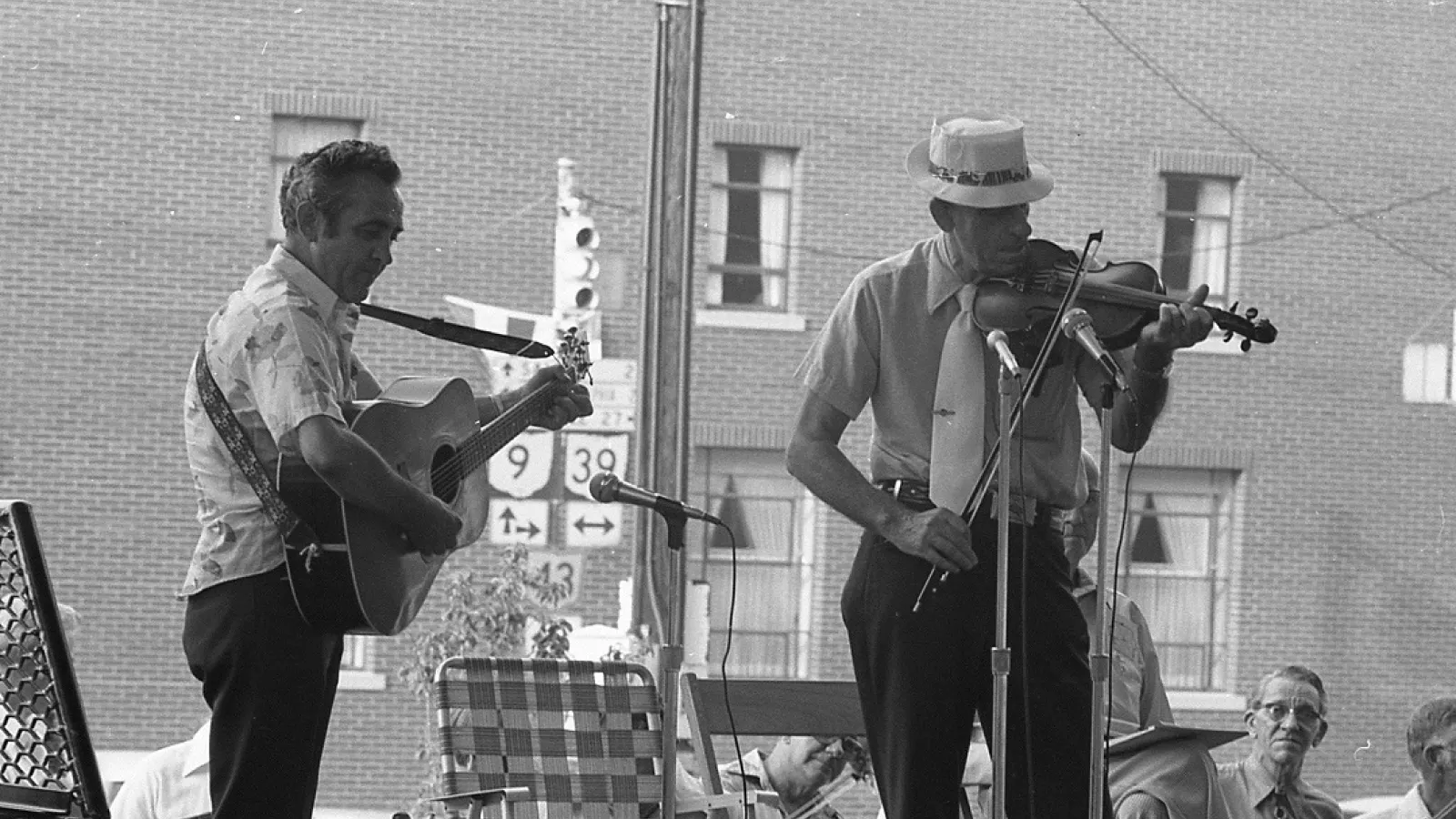 Two fiddlers on stage during a contest, 1977.