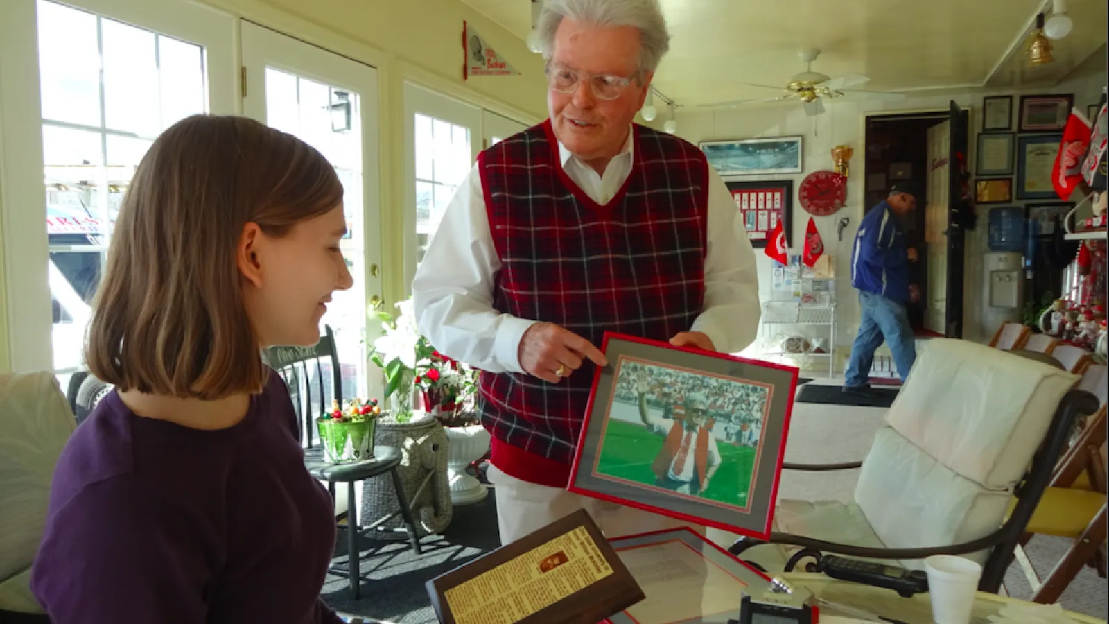 William McKinley shows Stephanie Fannin a photo of him being recognized at an OSU football game.