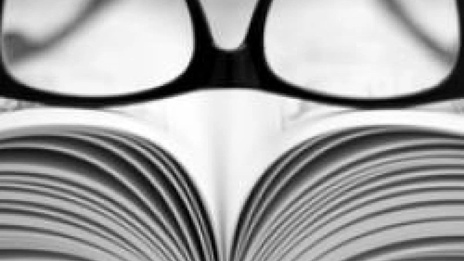 Glasses on top of open book