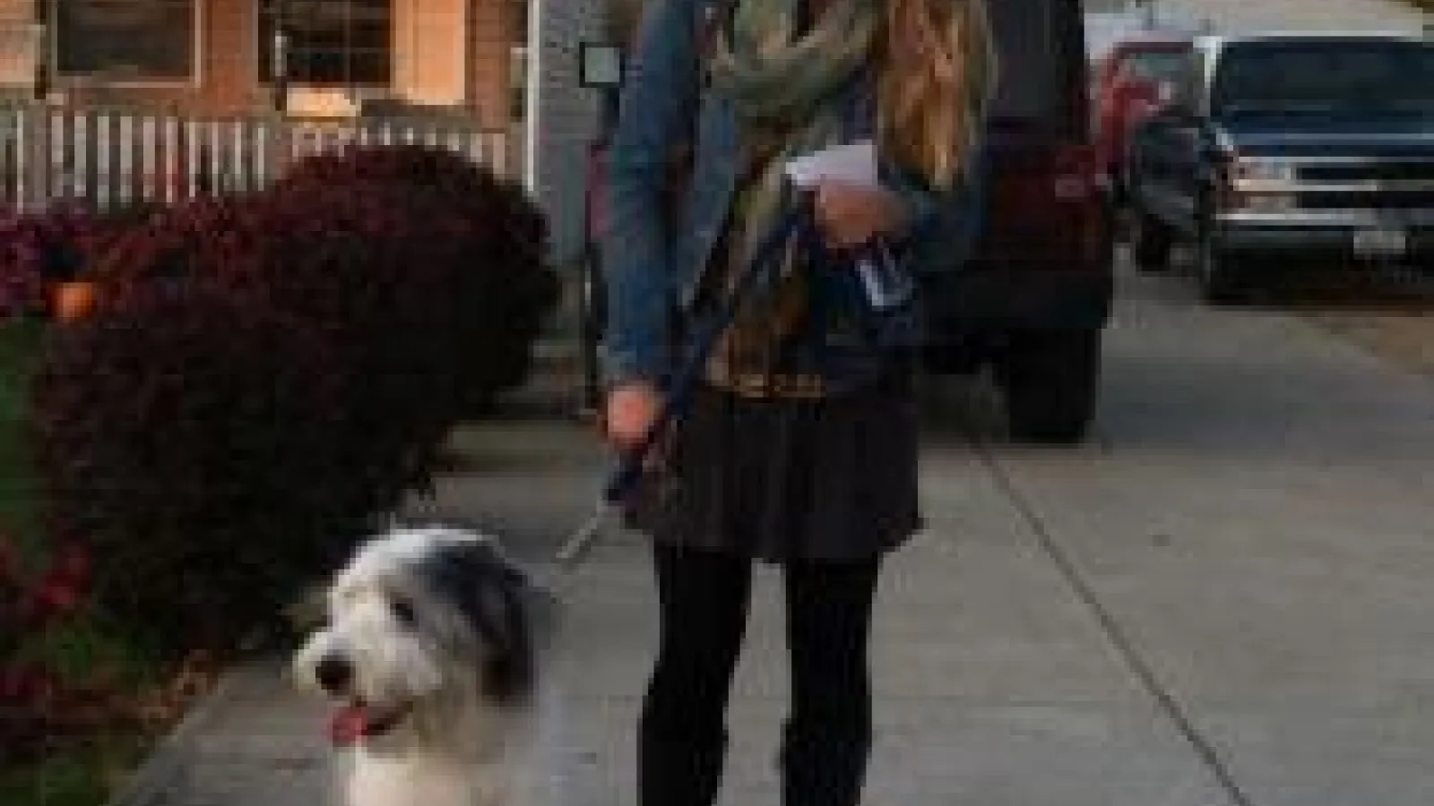 Kaitlyn Berle standing with a sheep dog