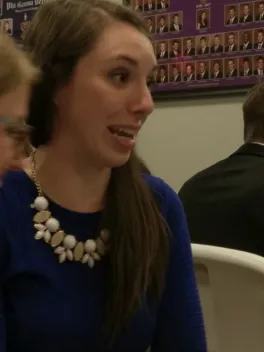 Young person with long hair in blue shirt
